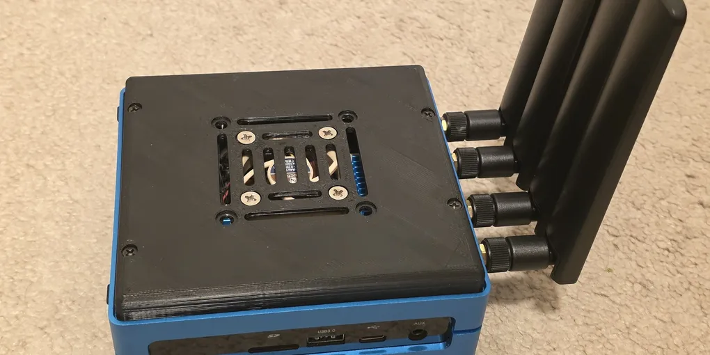 A custom 4G/5G router: a Seeed Odyssey x86 board in a blue aluminum case with a 3D-printed, Noctua-cooled lid and four cellular/WiFi antennas fanned out to one side.